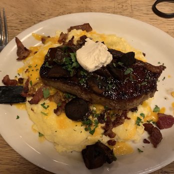 Flying Pig Pub & Kitchen - NY Strip steak over creamy grits with bacon & cheddar - Pubs Near Me - Oceanside, California Flying Pig Pub & Kitchen - NY Strip steak over creamy grits with bacon & cheddar - Pubs Near Me - Oceanside, California