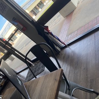 Novel Tea - a person sitting at a table with a laptop - Coffee & Tea Near Me - Casselberry, Florida