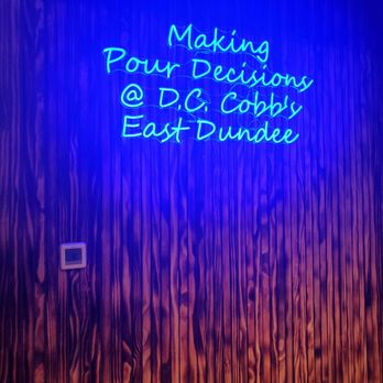 D.C. Cobb's - a neon sign on a wall - Burgers Near Me - East Dundee, Illinois