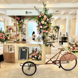 Scarlett Blooms - Custom floral installation for a client event--bold, vibrant blooms styled to elevate this branded cart activation by Scarlett Blooms.