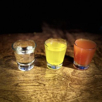 SuKasa - three glasses of juice on a wooden table - American Near Me - Hebbronville, Texas