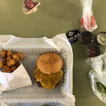 Tejas Burger Joint - Cheeseburger with tater tots with condiments - Burgers Near Me - Tomball, Texas Tejas Burger Joint - Cheeseburger with tater tots with condiments - Burgers Near Me - Tomball, Texas