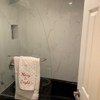 Take Pride Construction - Newly tiled shower, door installation, and shower shelf built - General Contractors Near Me