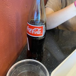 a bottle of coke and a donut