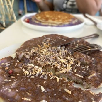 Bites & Bashes Cafe - Ube pancake stack shared on two plates. - Cafes Near Me - Lomita, California Bites & Bashes Cafe - Ube pancake stack shared on two plates. - Cafes Near Me - Lomita, California