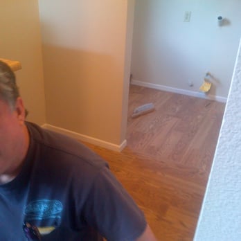Etchells Tile - a man standing in a room - General Contractors Near Me