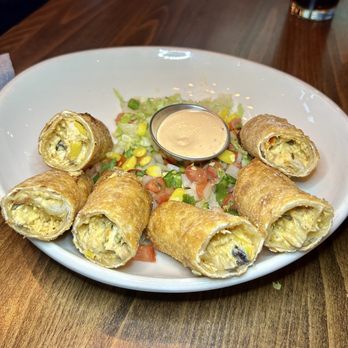 Five West - Southwest Egg Rolls Ancho cream cheese, rotisserie chicken, pico de gallo, black beans, corn, cilantro, and cheddar jack cheese. - New American Near Me - Rochester, Minnesota Five West - Southwest Egg Rolls Ancho cream cheese, rotisserie chicken, pico de gallo, black beans, corn, cilantro, and cheddar jack cheese. - New American Near Me - Rochester, Minnesota
