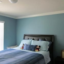 CertaPro Painters of Pearland - A comforting blue hue brings whimsy to a sophisticated bedroom.