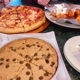 a table with a variety of pizzas