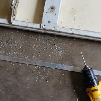 Maui Handy Pros - attaching aluminum stock to provide additional support to flimsy garage door panel. - Handyman Near Me Maui Handy Pros - attaching aluminum stock to provide additional support to flimsy garage door panel. - Handyman Near Me