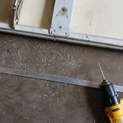 Maui Handy Pros - attaching aluminum stock to provide additional support to flimsy garage door panel.