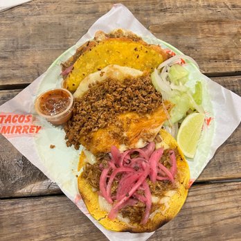 Tacos Mirrey - a plate of food on a wooden table - Tacos Near Me