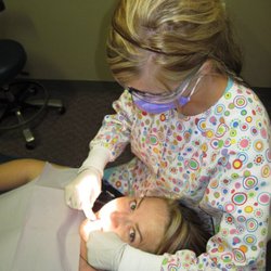 Weber Family Dentistry - Dental Hygienist assisting a child