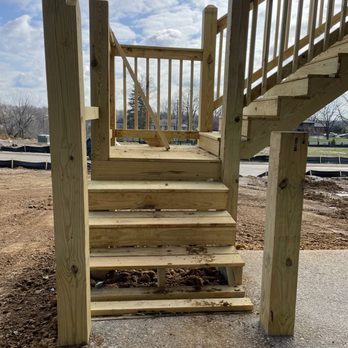 Elite Homes - Deck stair railings are not complete. Notice how the uncut post is not vertical. - General Contractors Near Me - Louisville, Kentucky Elite Homes - Deck stair railings are not complete. Notice how the uncut post is not vertical. - General Contractors Near Me - Louisville, Kentucky