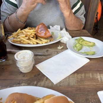 Hangout Restaurant & Beach Bar - Dad enjoying his burger with a side of fresh avocado - New American Near Me - Seal Beach, California Hangout Restaurant & Beach Bar - Dad enjoying his burger with a side of fresh avocado - New American Near Me - Seal Beach, California