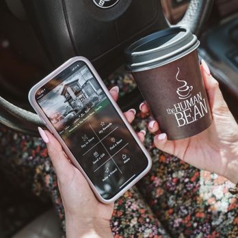 The Human Bean - a woman holding a cup of coffee and a cell phone - Coffee & Tea Near Me - Loveland, Colorado The Human Bean - a woman holding a cup of coffee and a cell phone - Coffee & Tea Near Me - Loveland, Colorado