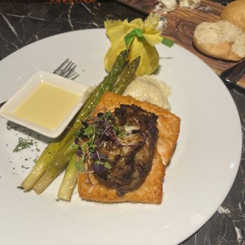 Fire Steakhouse - Crab pecan over grilled Salmon with asparagus and mashed potatoes. - Steakhouses Near Me - Atmore, Alabama Fire Steakhouse - Crab pecan over grilled Salmon with asparagus and mashed potatoes. - Steakhouses Near Me - Atmore, Alabama