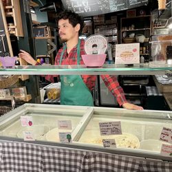 Marché Place Jacques Cartier - Server in front of ice cream case. Zoom in for flavors. Not sure if they rotate flavors or have the same ones all the time but SO GOOD.