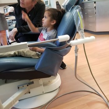 Young Smiles Pediatric Dentistry - Picking out the movie he wanted to watch - Pediatric Dentists Near Me - Temecula, California Young Smiles Pediatric Dentistry - Picking out the movie he wanted to watch - Pediatric Dentists Near Me - Temecula, California