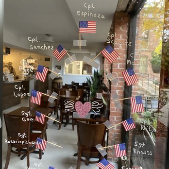 Mystic River Chocolate Cafe - a window display of american flags - Chocolatiers & Shops Near Me - Mystic, Connecticut