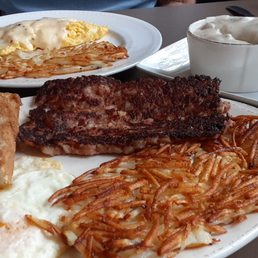 Cornbeef hash and eggs, cheese omelet with biscuit and gravy Cornbeef hash and eggs, cheese omelet with biscuit and gravy