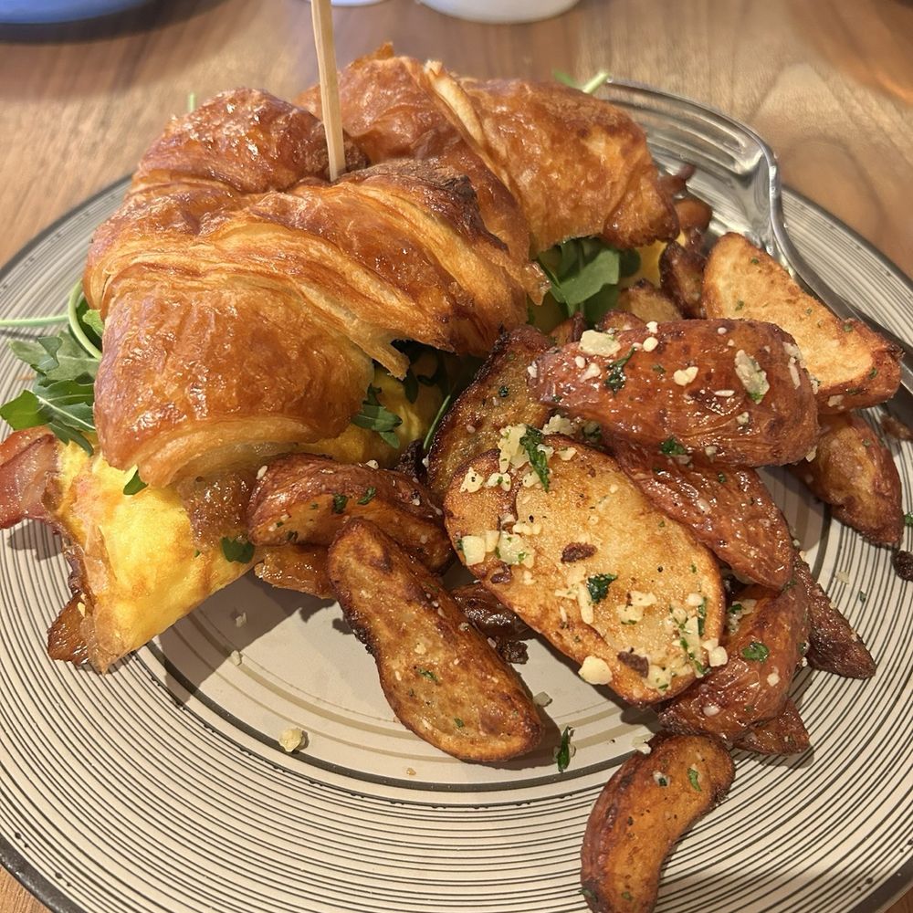 Sweetsong Kitchen & Bar - Bacon, Egg, Cheese with arugula croissant with potatoes. - Breakfast & Brunch Near Me - Duluth, Georgia Sweetsong Kitchen & Bar - Bacon, Egg, Cheese with arugula croissant with potatoes. - Breakfast & Brunch Near Me - Duluth, Georgia