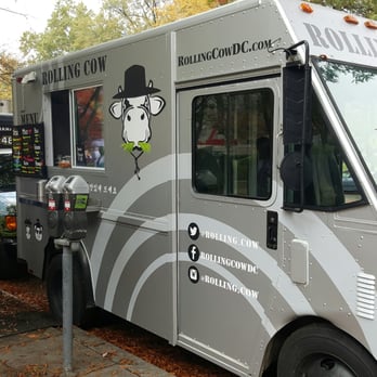 Rolling Cow - a man standing in front of a food truck - Food Trucks Near Me