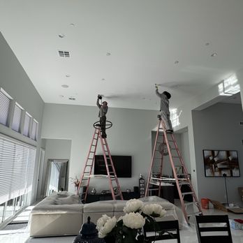 Friends Electric - Brandon and Joe on their ladders starting to install chandeliers - Electricians Near Me Friends Electric - Brandon and Joe on their ladders starting to install chandeliers - Electricians Near Me