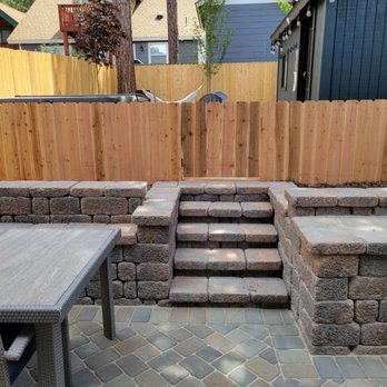 Roberts Outdoor - a patio with a table and chairs - Landscaping Near Me Roberts Outdoor - a patio with a table and chairs - Landscaping Near Me