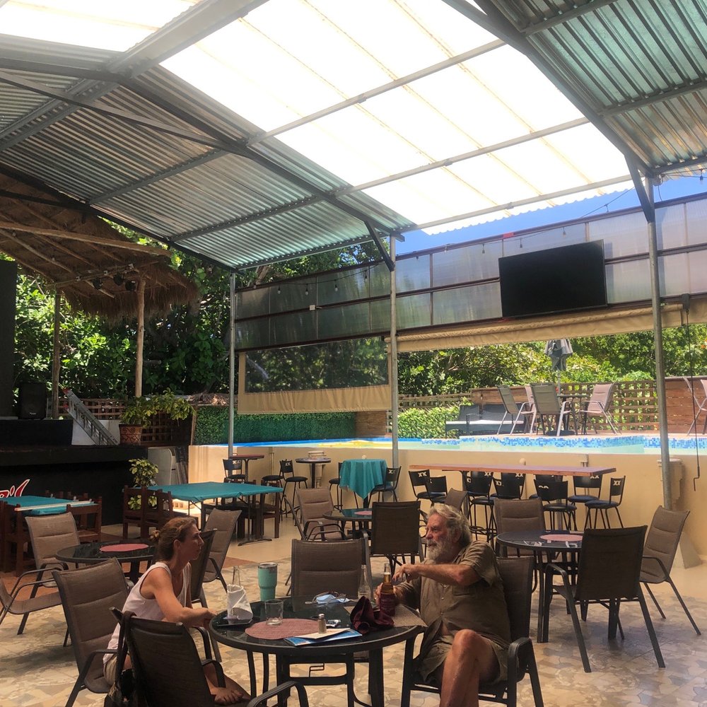 Snapper’s - Outside area with big screen tv and showing one of two swimming pools. - Bars Near Me - Isla Mujeres, ROO Snapper’s - Outside area with big screen tv and showing one of two swimming pools. - Bars Near Me - Isla Mujeres, ROO