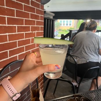 Luke & Mike's Frontporch - a person holding a drink - New American Near Me - Aspinwall, Pennsylvania