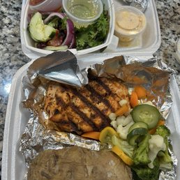 Blackened salmon Baked Potato Steamed Veggies salad.