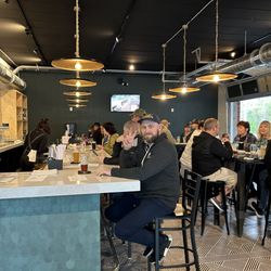 Wood Foot Beer - Interior seating -  entrance to patio on right and kitchen to immediate left.