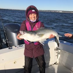 On The Bite Fishing Charters - Daughter with huge Striped Bass