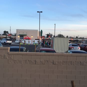 Krispy Kreme - Rear view of Krispy Kreme illustrating long lines at evening waiting to step in building for donuts. - Donuts Near Me - Tucson, Arizona Krispy Kreme - Rear view of Krispy Kreme illustrating long lines at evening waiting to step in building for donuts. - Donuts Near Me - Tucson, Arizona