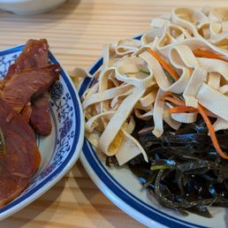 One free small side dish sampler (left) as their soft opening special. Seaweed and bean curd skin we ordered (right). One free small side dish sampler (left) as their soft opening special. Seaweed and bean curd skin we ordered (right).
