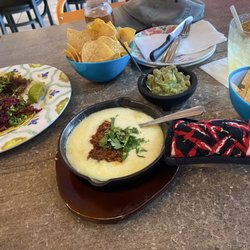 La Mordida - Barbacoa and carnitas tacos, queso fundito y chrizo, and guacamole.