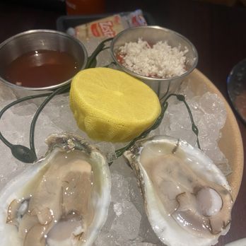 Bludorn - Raw oysters on the half shell with cocktail and mignonette sauces - New American Near Me - Houston, Texas Bludorn - Raw oysters on the half shell with cocktail and mignonette sauces - New American Near Me - Houston, Texas