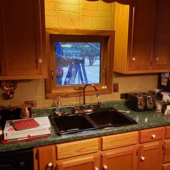 Wisconsin Windows - a kitchen with wooden cabinets and a flat screen tv - Windows Installation Near Me - Neenah, Wisconsin Wisconsin Windows - a kitchen with wooden cabinets and a flat screen tv - Windows Installation Near Me - Neenah, Wisconsin
