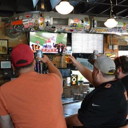 The Hi-Mark - Guests cheering while watching a game at The Hi-Mark