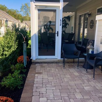 American Dream Landscaping - a patio with chairs and a table - Landscaping Near Me American Dream Landscaping - a patio with chairs and a table - Landscaping Near Me
