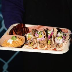Jerk chicken tacos house made sausage street corn