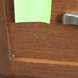 Dan Blaugh Construction - The nail comes through the cabinet at the bottom. Their comment "that's normal."