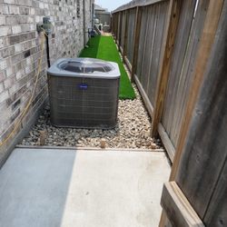 Lugo's Outdoor Services - Weeds pulled and river rock laid around AC unit and fence line.