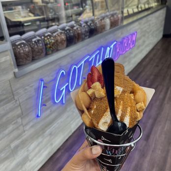 Eiffel Waffle - a hand holding a waffle waffle cone - Desserts Near Me - Downers Grove, Illinois Eiffel Waffle - a hand holding a waffle waffle cone - Desserts Near Me - Downers Grove, Illinois