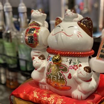 Kazoku Ramen - a white cat with a red cushion - Ramen Near Me - Edmonton, Alberta Kazoku Ramen - a white cat with a red cushion - Ramen Near Me - Edmonton, Alberta