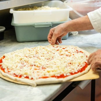 Bazzarelli - a person making a pizza - Italian Near Me - Moonachie, New Jersey