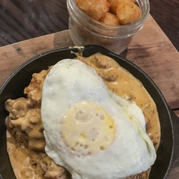 Copper Fox Gastropub - Biscuits and Sausage Gravy ($10) with a perfectly fried egg on top ($2) and a side of crispy tots - New American Near Me - Chicago, Illinois
