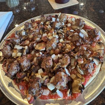Tomaso's - Thin crust lunch pizza sausage, bacon, mushrooms and onion. Huge portions of toppings. Excellent value and great service - Wine Bars Near Me - Appleton, Wisconsin