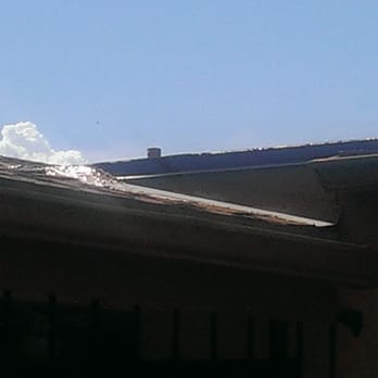 Payne Roofing - On the left portion you will see a huge glob of caulking to seal up the transition between the garage and the house. - Roofing Near Me - Gilbert, Arizona